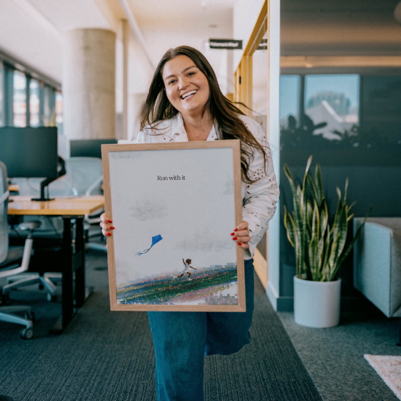 A framed print from Orb's new brand, held up in an office